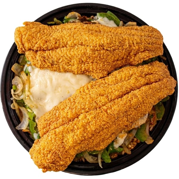 Two crispy fried fish fillets over rice, green peppers, onions, and melted cheese in a black bowl.