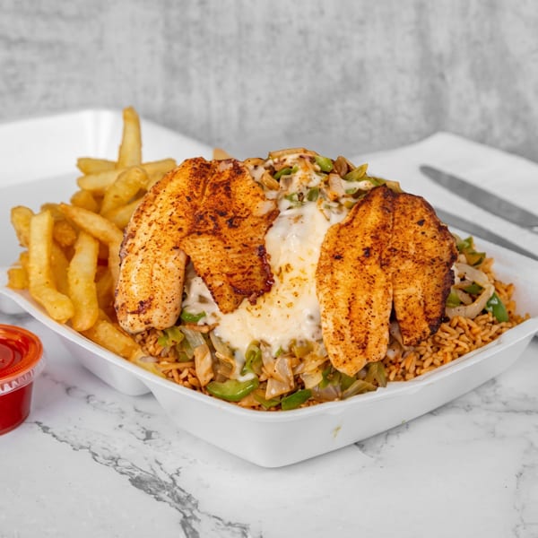 Two seasoned fish fillets with melted cheese over rice and vegetables, with fries and sauce cups.